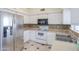 A kitchen with white cabinetry, stainless steel refrigerator and sink at 1297 E Avenida Kino --, Casa Grande, AZ 85122