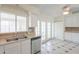 Clean kitchen with white cabinets, stainless steel dishwasher and view to patio doors at 1297 E Avenida Kino --, Casa Grande, AZ 85122