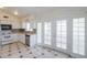 Well-lit kitchen featuring white cabinetry, stainless steel appliances, and access to patio doors at 1297 E Avenida Kino --, Casa Grande, AZ 85122