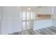 Open kitchen with stylish flooring, white cabinetry, and breakfast bar at 1297 E Avenida Kino --, Casa Grande, AZ 85122
