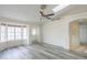 Bright and airy living room featuring wood-look floors, a ceiling fan, and ample natural light at 1297 E Avenida Kino --, Casa Grande, AZ 85122