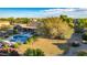 Aerial view of the property featuring a pool, lush landscaping, and a spacious backyard with mature trees at 14022 W Hope Dr, Surprise, AZ 85379