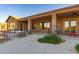Spacious covered patio with outdoor seating, grill, and mature plants, ideal for relaxing or entertaining at 14022 W Hope Dr, Surprise, AZ 85379