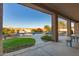 Covered patio with view of sparkling pool, lush landscaping, and ample seating, perfect for outdoor entertaining at 14022 W Hope Dr, Surprise, AZ 85379