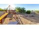Backyard play area with a playset, tire swing, and sandbox, perfect for to enjoy outdoor fun at 14022 W Hope Dr, Surprise, AZ 85379