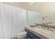 Bathroom with shower and tub combination, marble countertop, and blue vanity at 14022 W Hope Dr, Surprise, AZ 85379