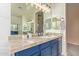 Bathroom featuring dual sinks, and spacious countertops, with vanity lights at 14022 W Hope Dr, Surprise, AZ 85379
