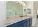 Spacious bathroom vanity area featuring dual sinks and large mirror with vanity lights at 14022 W Hope Dr, Surprise, AZ 85379