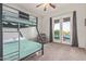 Bedroom with bunk beds, French doors leading to the backyard, and neutral colored walls at 14022 W Hope Dr, Surprise, AZ 85379