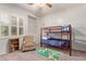 Comfortable bedroom features bunk beds, a colorful rug, and neutral carpet at 14022 W Hope Dr, Surprise, AZ 85379