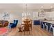 Open concept dining room with a wood table, chandelier and lots of natural light at 14022 W Hope Dr, Surprise, AZ 85379