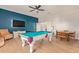 Game room with a pool table, TV, and wood flooring at 14022 W Hope Dr, Surprise, AZ 85379