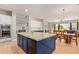 Spacious kitchen featuring an island with seating, built-in appliances, and an adjacent dining area at 14022 W Hope Dr, Surprise, AZ 85379
