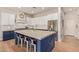 Stylish kitchen with white cabinets, granite countertops, subway tile backsplash, stainless appliances and an island with seating at 14022 W Hope Dr, Surprise, AZ 85379