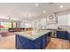 Bright kitchen with a large island, stainless steel appliances, and white cabinets at 14022 W Hope Dr, Surprise, AZ 85379
