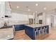 Stylish kitchen with white cabinets, granite countertops, subway tile backsplash, stainless appliances and an island with seating at 14022 W Hope Dr, Surprise, AZ 85379