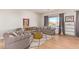 Comfortable living room featuring modern sofas, a stylish coffee table, and ample natural light at 14022 W Hope Dr, Surprise, AZ 85379