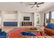 Cozy living room with a ceiling fan and a view to the backyard at 14022 W Hope Dr, Surprise, AZ 85379