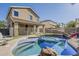The backyard pool area with slide is perfect for Gathering fun and entertaining guests with beautiful landscaping at 14874 W Laurel Ln, Surprise, AZ 85379