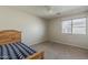 Bedroom with carpet, neutral paint, ceiling fan, and natural wood accents at 14874 W Laurel Ln, Surprise, AZ 85379