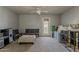 Bonus room with carpet, ceiling fan, back door, and play kitchen; ready for your creative vision at 14874 W Laurel Ln, Surprise, AZ 85379