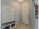 Entryway features a built-in bench and coat rack with tile flooring at 14874 W Laurel Ln, Surprise, AZ 85379