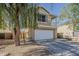 Two-story home with a balcony, a two-car garage, and desert landscaping at 14874 W Laurel Ln, Surprise, AZ 85379