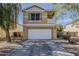 Two-story home with a balcony, a two-car garage, and desert landscaping at 14874 W Laurel Ln, Surprise, AZ 85379