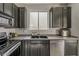 This updated kitchen features sleek, dark cabinetry, stainless steel appliances, and durable countertops at 14874 W Laurel Ln, Surprise, AZ 85379