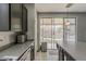 Well-designed kitchen with dark cabinets, stainless appliances, and easy access to the backyard through sliding glass doors at 14874 W Laurel Ln, Surprise, AZ 85379