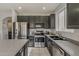 Updated kitchen with stainless steel appliances and stylish cabinetry offers a modern and functional cooking space at 14874 W Laurel Ln, Surprise, AZ 85379