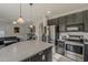 Open-concept kitchen features stainless steel appliances and blends seamlessly with the adjacent living area at 14874 W Laurel Ln, Surprise, AZ 85379