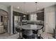 Bright kitchen with dark cabinets and stainless steel appliances offers a functional and stylish cooking space at 14874 W Laurel Ln, Surprise, AZ 85379
