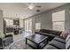 Open-concept living room integrates kitchen access with comfortable seating for entertaining and relaxation at 14874 W Laurel Ln, Surprise, AZ 85379