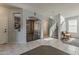 Spacious living area with tile floors, staircase, and built-in shelving at 14874 W Laurel Ln, Surprise, AZ 85379