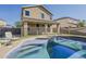 Inviting backyard pool features a safety fence and ample space for relaxation, perfect for summer fun at 14874 W Laurel Ln, Surprise, AZ 85379