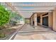 A spacious covered patio features shade and light, with access to the house and a view to the backyard at 15035 W Indianola Ave, Goodyear, AZ 85395