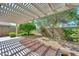 Spacious backyard with desert landscaping, a covered patio, and mature trees at 15035 W Indianola Ave, Goodyear, AZ 85395