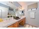 Bright bathroom featuring dual sinks, ample counter space, and well-lit mirrors, perfect for daily routines at 15035 W Indianola Ave, Goodyear, AZ 85395