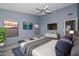 Comfortable bedroom with large windows, TV, and plush bedding provides a relaxing and inviting atmosphere at 15035 W Indianola Ave, Goodyear, AZ 85395