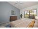 Serene bedroom with large windows, a modern dresser, and calming decor creates a peaceful retreat at 15035 W Indianola Ave, Goodyear, AZ 85395