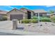 Charming home with a two-car garage, beautiful landscaping, and a well-maintained yard at 15035 W Indianola Ave, Goodyear, AZ 85395