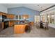 Well-lit kitchen with a breakfast bar and adjacent dining area provides ample space for cooking and casual dining at 15035 W Indianola Ave, Goodyear, AZ 85395