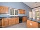 Charming kitchen featuring wooden cabinets, granite countertops, and an open layout at 15035 W Indianola Ave, Goodyear, AZ 85395