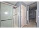 Bathroom with tiled shower stall with a glass door and a towel rack at 15035 W Indianola Ave, Goodyear, AZ 85395