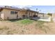 A spacious backyard has a patio with a grill, grass, and a refreshing swimming pool at 15619 N 58Th Ave, Glendale, AZ 85306