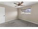 Relaxing bedroom with neutral carpet, a window, and a door at 15619 N 58Th Ave, Glendale, AZ 85306