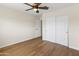 This bedroom offers hardwood flooring and features an enclosed closet with sliding doors at 15619 N 58Th Ave, Glendale, AZ 85306