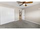 Comfortable bedroom with neutral carpet, a double door closet, and a view to the entryway at 15619 N 58Th Ave, Glendale, AZ 85306