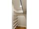 Walk-in closet featuring custom shelving and ample storage space for organization at 15619 N 58Th Ave, Glendale, AZ 85306